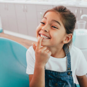 Family dental image, child smiling while at the dentist