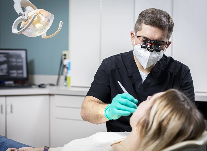 Dentist performing a dental examination for a patient at Ryan Long Dental in Dayton, Ohio